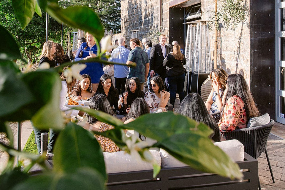 Guests mingling and eating in outdoor patio