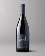 Bottle of Robert Mondavi Winery The Estates Pinot Noir Carneros on a gray background.