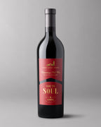 A bottle of Ode to Soul Proprietary Red Wine on a gray background
