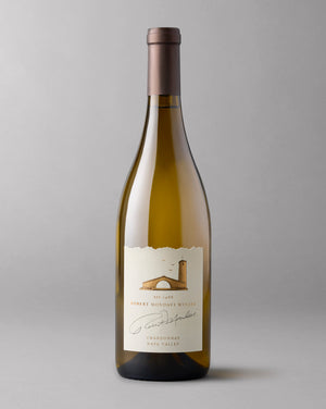 A bottle of 2021 Chardonnay Napa Valley on a grey background.