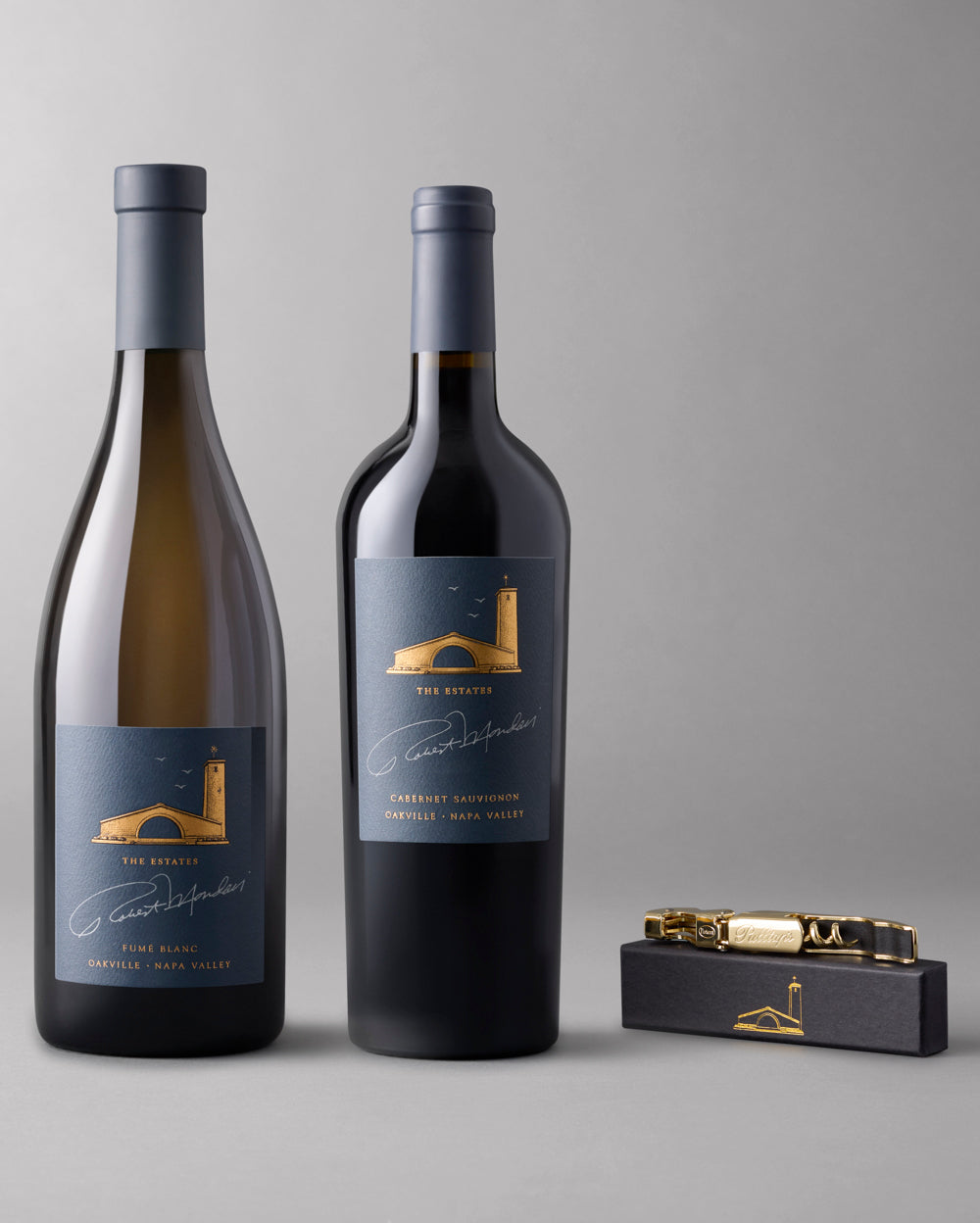 A bottle of Estates Fume Blanc and Estates Cabernet Sauvignon paired with a gold corkscrew.