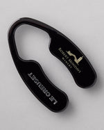 The black Robert Mondavi Winery x Le Creuset Foil Cutter on a gray background